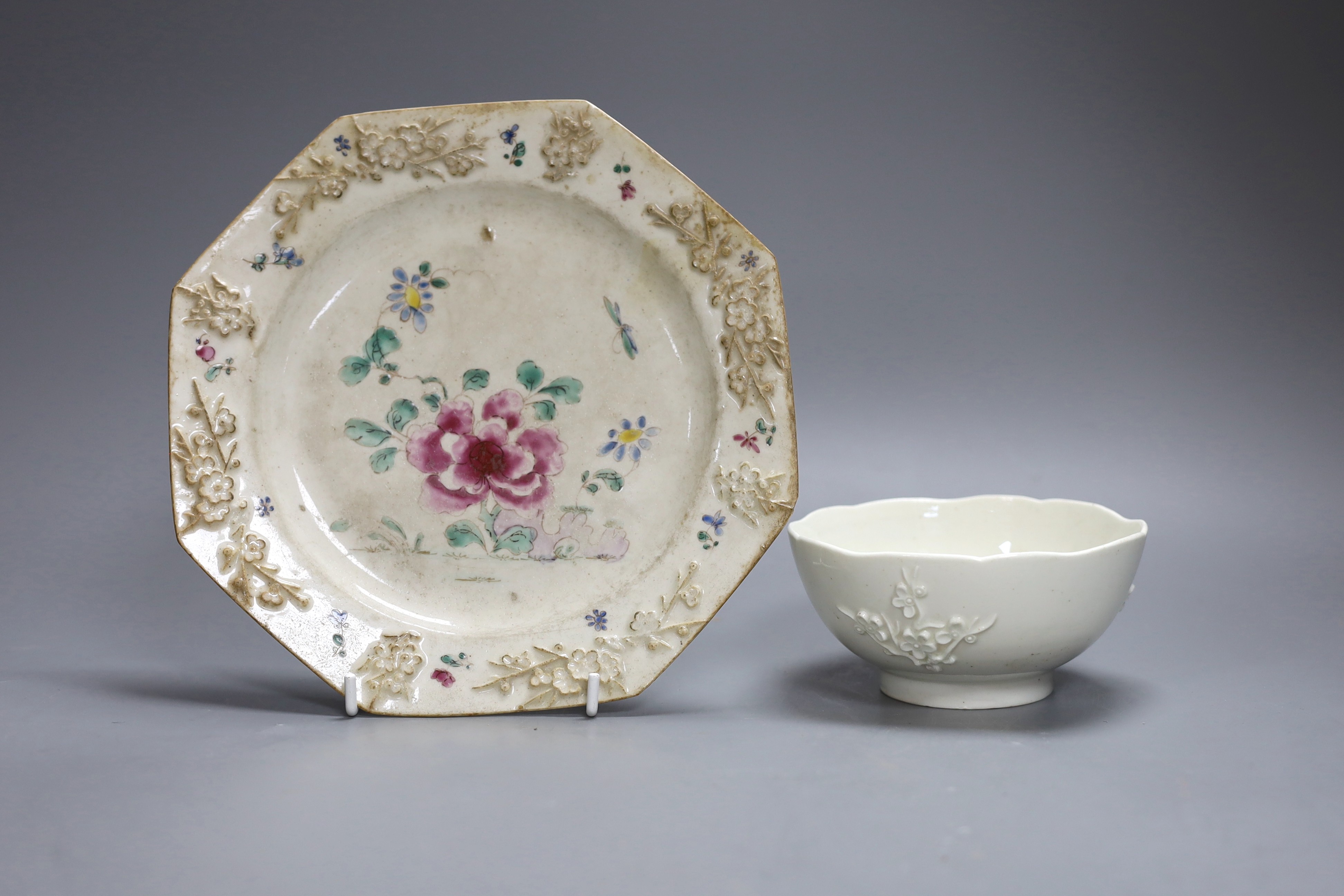 An 18th century Bow white glazed ‘prunus’ bowl, and a Bow octagonal plate, with floral design, 21cm diameter